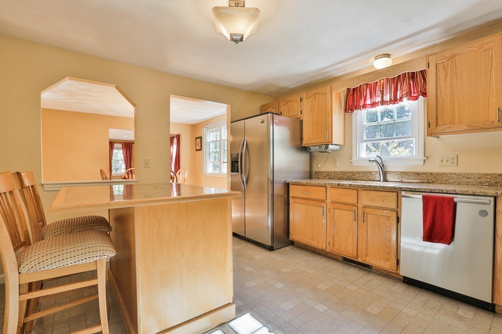 20 Patten Road Tewksbury, MA 01876 - Photo 4 of 29 a kitchen with stainless steel appliances granite countertop a refrigerator and a stove top oven