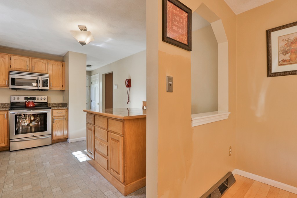 20 Patten Road Tewksbury, MA 01876 - Photo 5 of 29 a kitchen with stainless steel appliances a stove and a refrigerator