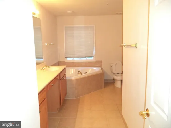 a bathroom with a sink a toilet and tub
