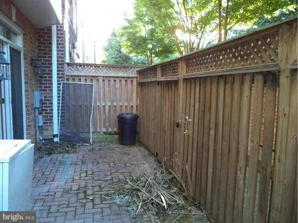 a view of a backyard with a wooden fence