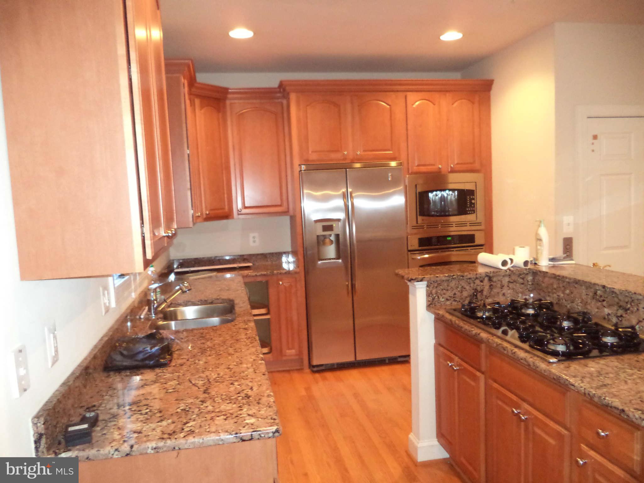 6812 Rigby Lane McLean, VA 22101 - Photo 7 of 23 a kitchen with stainless steel appliances granite countertop a refrigerator and a stove
