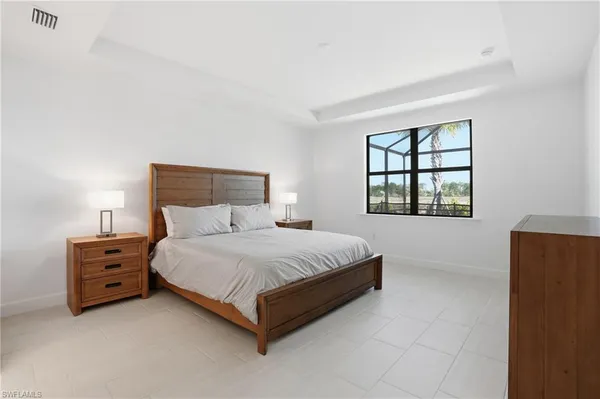a spacious bedroom with a bed and a window