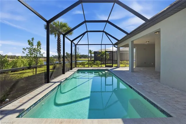 a view of two chairs and table in a balcony