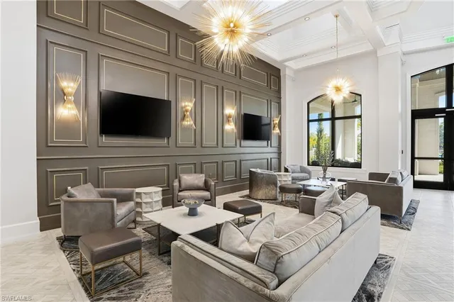 a living room with furniture and a chandelier