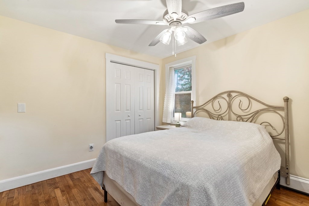 7 Meadowbrook Lane Ashland, MA 01721 - Photo 16 of 18 a bedroom with a bed and a chandelier