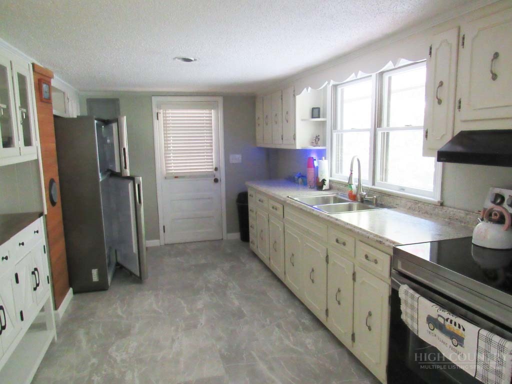 805 Ed Little Road Warrensville, NC 28693 - Photo 46 of 49 a kitchen with a sink stove and refrigerator