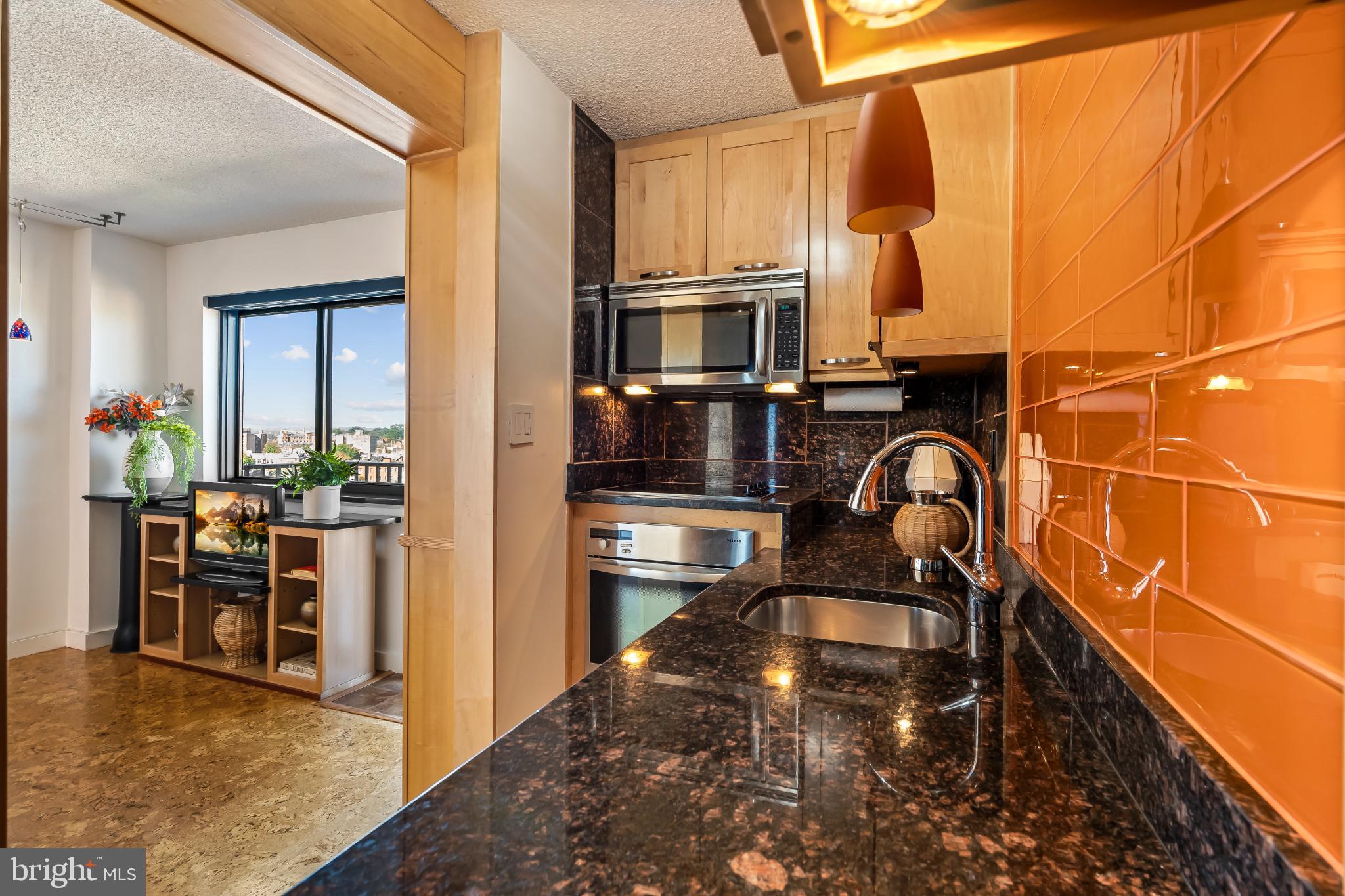 1816 New Hampshire Avenue Northwest, Unit 1009 Washington, DC 20009 - Photo 12 of 23 a kitchen with a sink and a stove top oven
