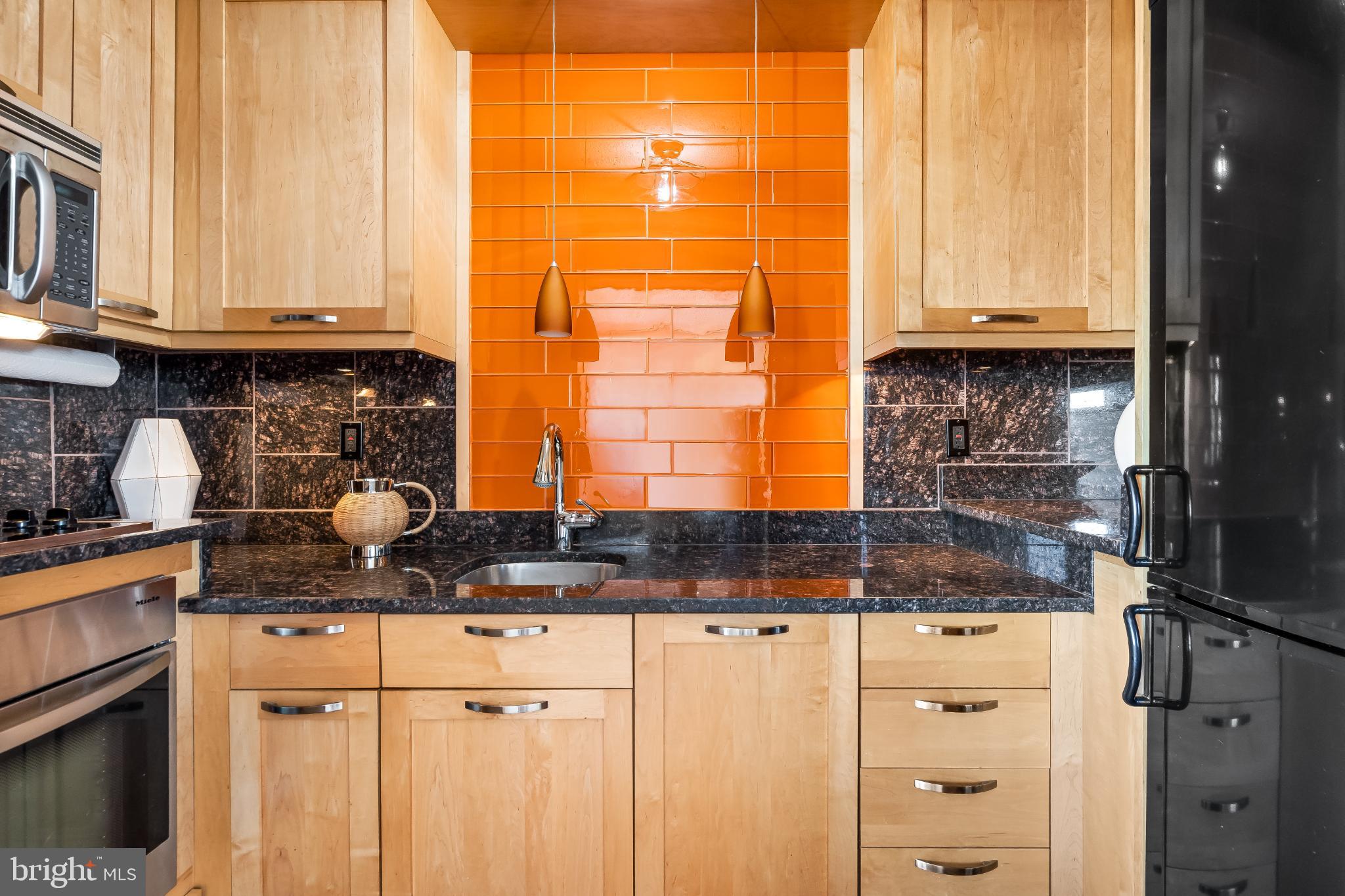 1816 New Hampshire Avenue Northwest, Unit 1009 Washington, DC 20009 - Photo 13 of 23 a kitchen with stainless steel appliances granite countertop a sink and cabinets