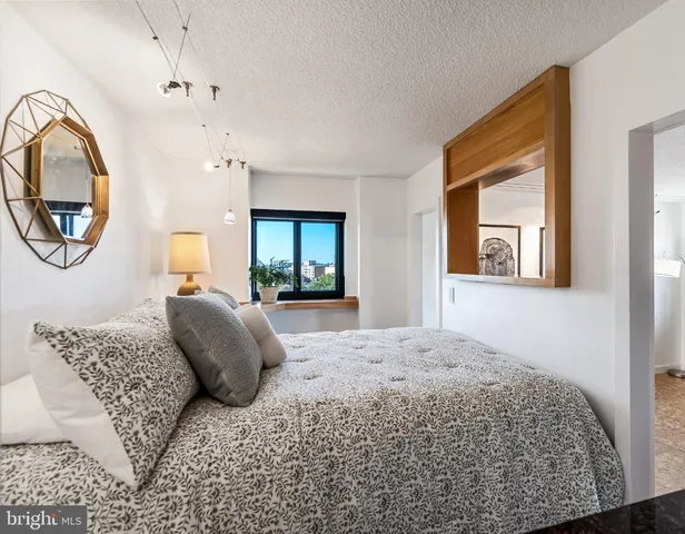 a potted plant sitting on top of a window sill and a wooden floor