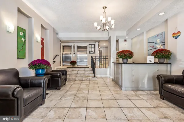 a living room with furniture and a chandelier
