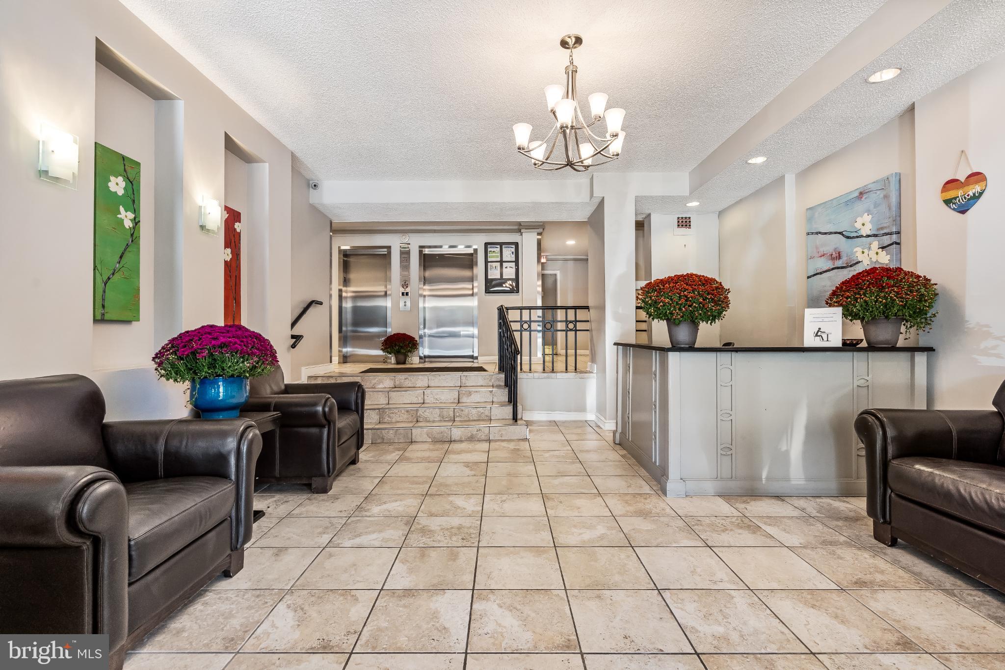 1816 New Hampshire Avenue Northwest, Unit 1009 Washington, DC 20009 - Photo 2 of 23 a living room with furniture and a chandelier