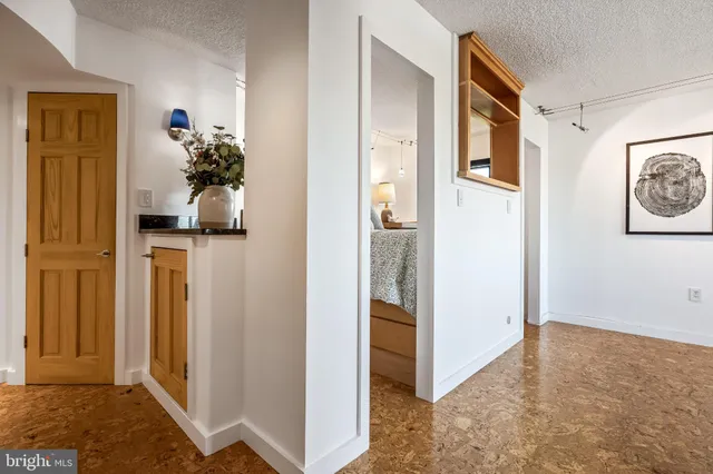 a view of a hallway with paintings on the wall