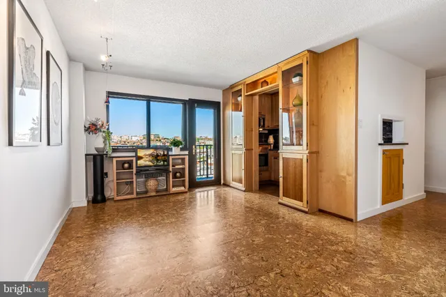a view of kitchen with furniture and refrigerator