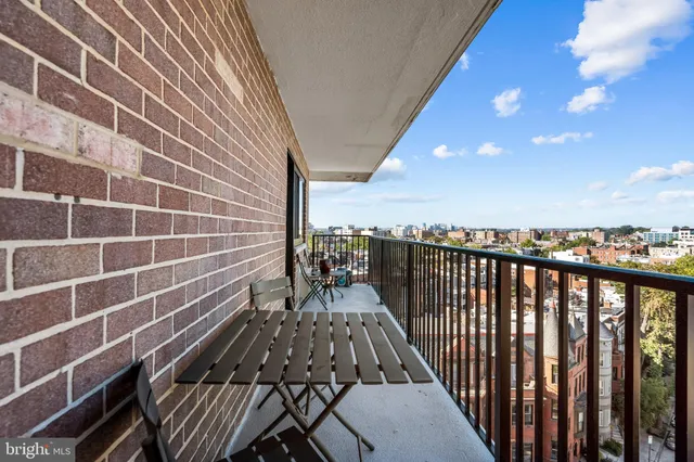 a view of a balcony with wooden floor and city view
