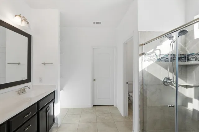 a bathroom with a double vanity sink and mirror