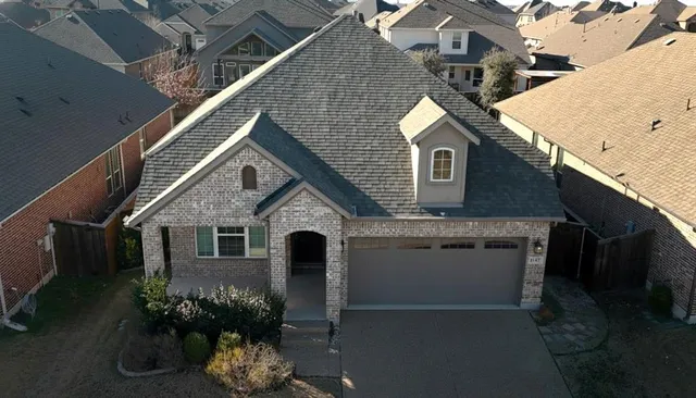 a front view of a house with a yard garage and outdoor seating