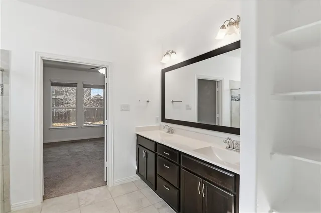 a bathroom with a granite countertop sink mirror and a