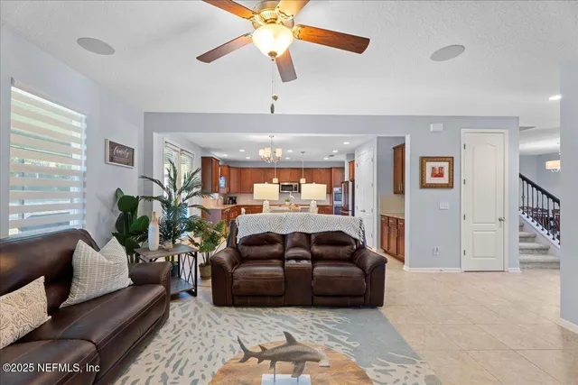 a living room with furniture and a chandelier
