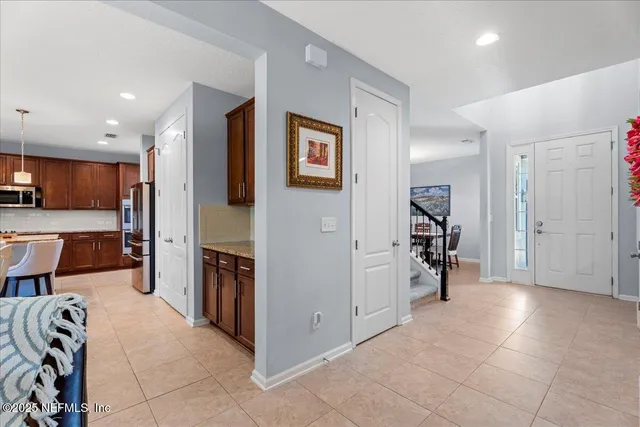 a view of a kitchen with furniture and a refrigerator
