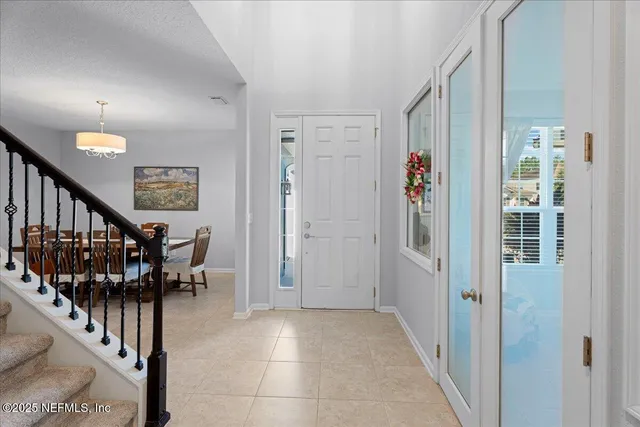 a view of entryway with wooden floor and stairs