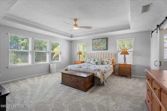 a spacious bedroom with a bed and a large window