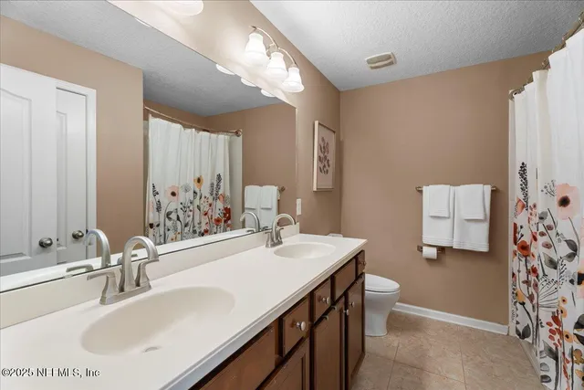 a bathroom with a sink double vanity and a mirror