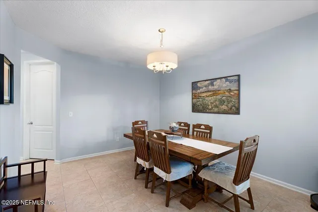 a dining room with a table and chairs
