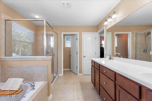 a spacious bathroom with a granite countertop sink and a mirror