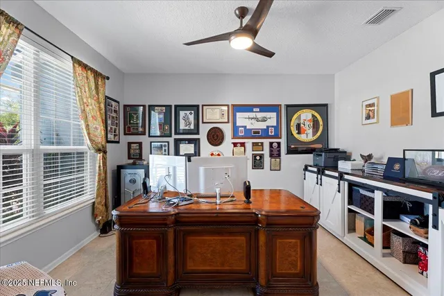 a living room with furniture and paintings on the wall