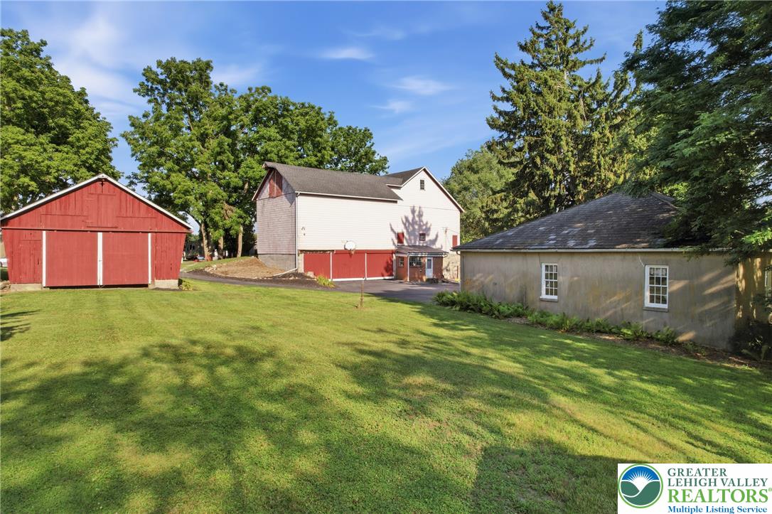 4682 Steuben Road Bethlehem, PA 18020 - Photo 65 of 79 A spacious yard with verdant lawns connects a charming red barn to a multi-level structure.