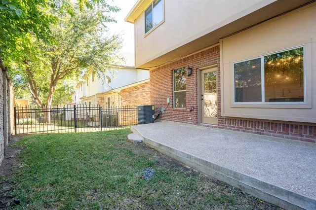 a view of a house with a yard and sitting area