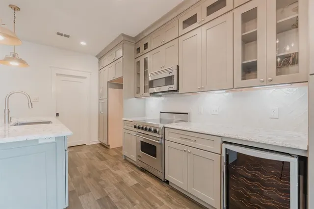a kitchen with stainless steel appliances granite countertop a stove and a sink