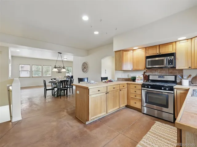 a kitchen with microwave a stove and cabinets