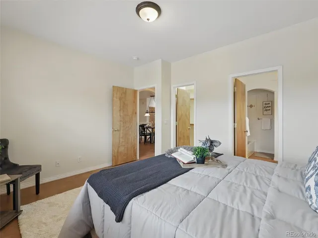 a bedroom with a bed and wooden floor