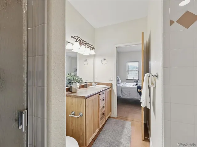 a bathroom with a granite countertop sink and a mirror