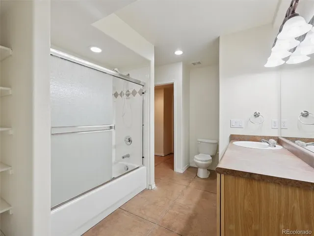 a spacious bathroom with a granite countertop sink and a mirror
