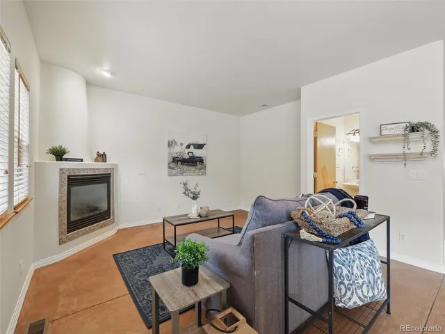 a living room with furniture rug and window