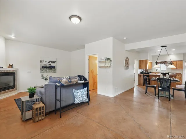 a living room with furniture and kitchen view