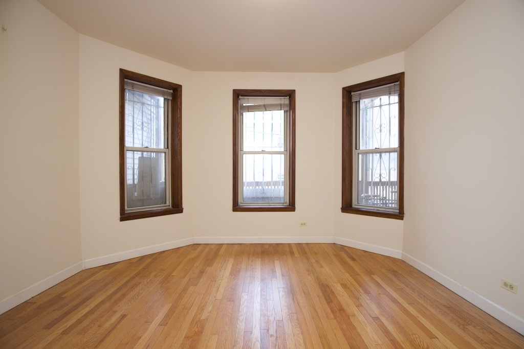 6711 North Sheridan Road, Unit 3S Chicago, IL 60626 - Photo 16 of 20 an empty room with wooden floor and windows