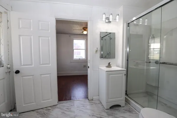 a bathroom with a shower a sink and a mirror