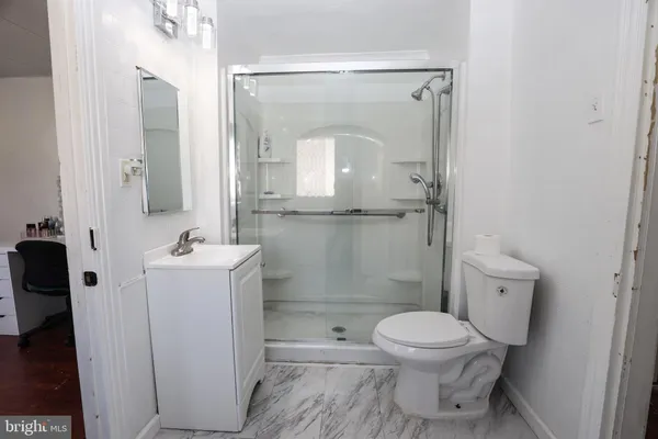 a bathroom with a toilet a sink and a mirror