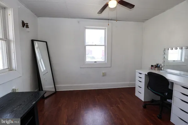 a view of a workspace with furniture and a window