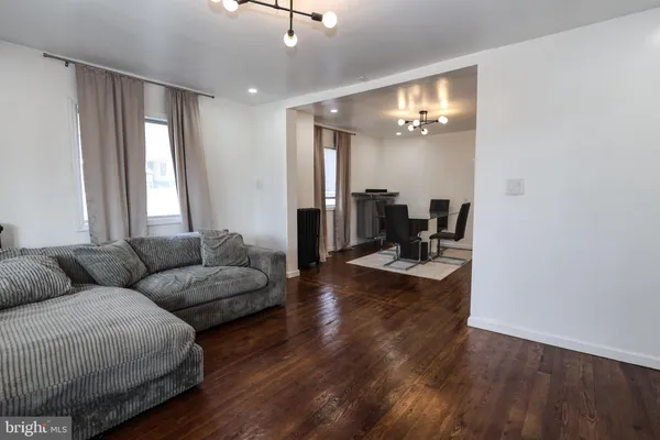 a living room with furniture and wooden floor