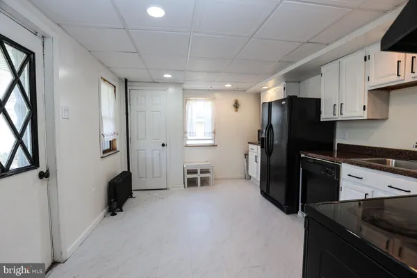 a kitchen with stainless steel appliances a refrigerator and a stove top oven