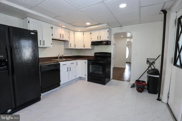 a kitchen with stainless steel appliances a refrigerator and a stove