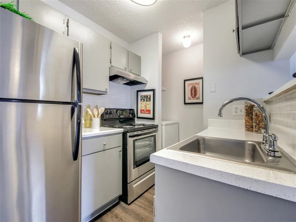 7610 Cameron Road, Unit 375 Austin, TX 78752 - Photo 4 of 42 a kitchen with a refrigerator sink and stove