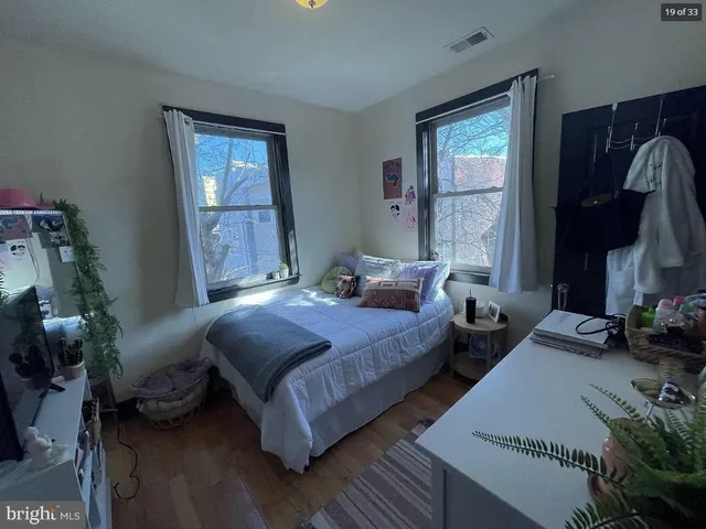 a bedroom with bed and a window