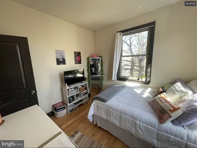 a bedroom with a bed and a flat tv screen