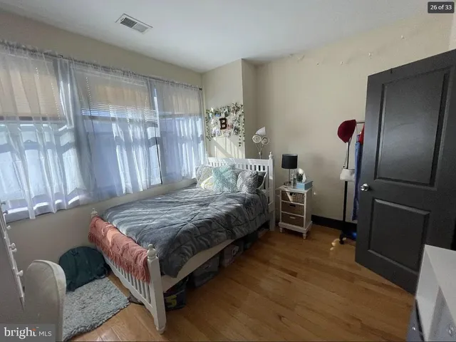 a bedroom with a bed dresser and a window