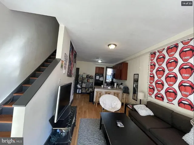 a living room with furniture and a dining table